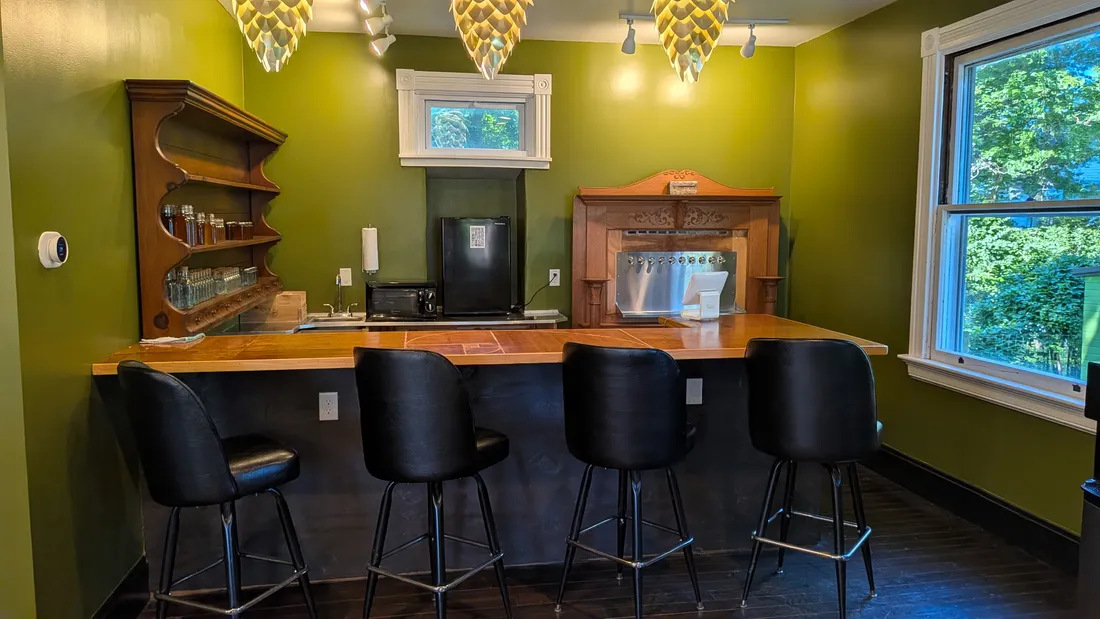 The tap bar with stools and back-bar shelving